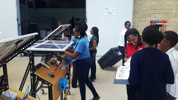 Trainees practising solar PV installation on training rigs during a solar technician course in Nairobi